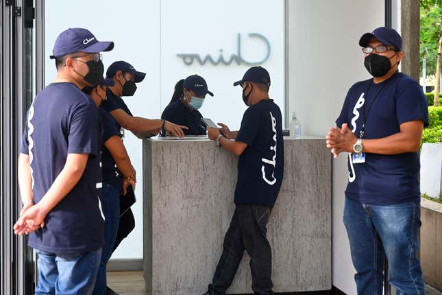 Government employees prepare to receive people who want to use the bitcoin ATM during an outage of the Chivo Wallet system in San Salvador, on September 7, 2021. 