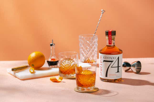 Bottle of Spiritless Kentucky 74 non-alcoholic bourbon whiskey and zero-proof old fashioned cocktail