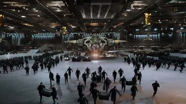 UNSC soldiers run through a military hangar filled with Pelicans and Warthogs, carrying gear.