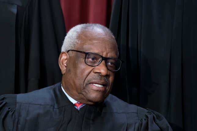 Associate Justice Clarence Thomas joins other members of the Supreme Court as they pose for a new group portrait, at the Supreme Court building in Washington, Friday, Oct. 7, 2022.