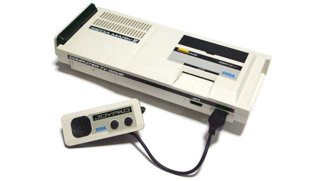 The Sega Mark III console is seen in a white void.