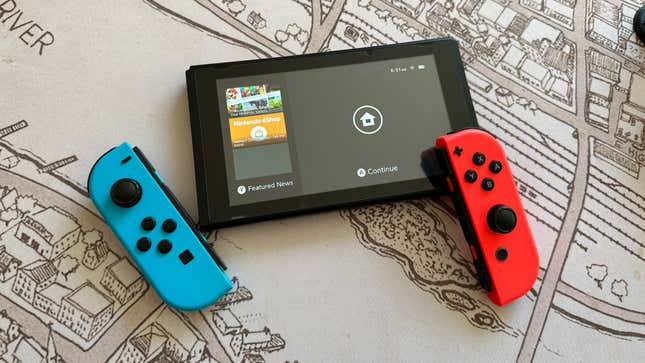 A Nintendo Switch with both JoyCons removed on top of a map