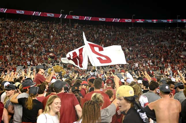 Sep 9, 2023; Pullman, Washington, USA; Washington State Cougars fans rush there field after a game against the Wisconsin Badgers at Gesa Field at Martin Stadium. Washington State won 31-22.