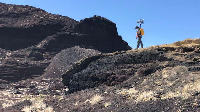NASA Planetary Scientist Michael Zanetti testing out the backpack in Potrillo volcanic field in New Mexico.