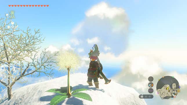 Link se tient devant un pissenlit Korok sur une colline enneigée.