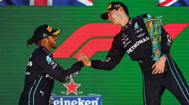 Race winner George Russell of Great Britain and Mercedes and Second placed Lewis Hamilton of Great Britain and Mercedes celebrate on the podium during the F1 Grand Prix of Brazil at Autodromo Jose Carlos Pace on November 13, 2022 in Sao Paulo, Brazil. 