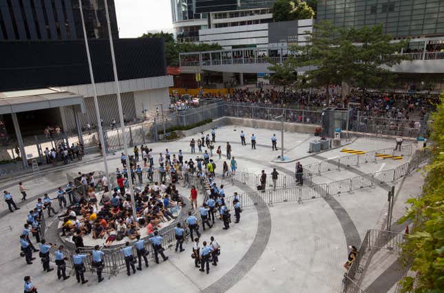 Student protesters are kettled by police at the Civic Square, the public area in front of Hong Kong's Central government offices, in Hong Kong, China, 27 September 2014. The students were overcoming police barriers overnight and occupied the area as part of their week-long protest against Beijing's rules for Hong Kong elections. Police reportedly were denying the students access to a bathroom as well as to food or water. EPA/ALEX HOFFORD
