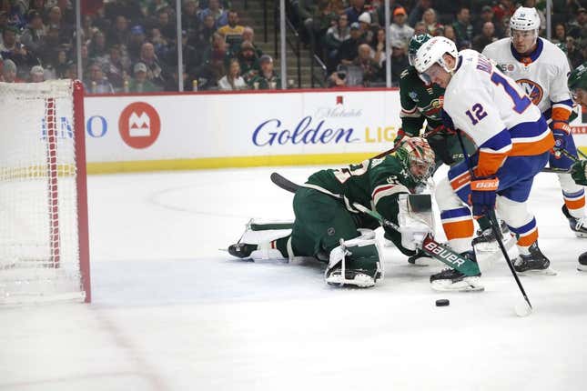 Feb 28, 2023; Saint Paul, Minnesota, USA;  New York Islanders right wing Josh Bailey (12) puts the puck past Minnesota Wild goaltender Filip Gustavsson (32) to score the first goal during the 1st period between the Minnesota Wild and the New York Islanders at Xcel Energy Center.