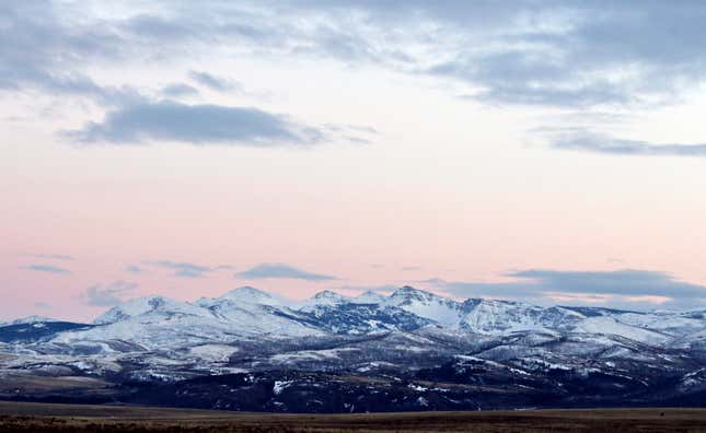 FILE - In this March 25, 2016, file photo, the sun sets over the Badger-Two Medicine area near Browning, Mont. A Louisiana company will relinquish the last remaining oil and gas lease on land near Montana&#39;s Glacier National Park that&#39;s sacred to Native Americans in the U.S. and Canada, under a legal agreement announced Friday, Sept. 1, 2023, that would resolve a decades-long dispute. (Greg Lindstrom/Flathead Beacon via AP, File)