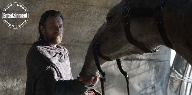 Obi-Wan Kenobi petting an animal that looks like a horse-elephant hybrid.