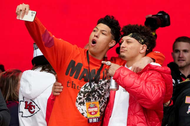 Jackson (l.) and Patrick Mahomes celebrate on stage during the Kansas City Chiefs Super Bowl LVII victory parade.