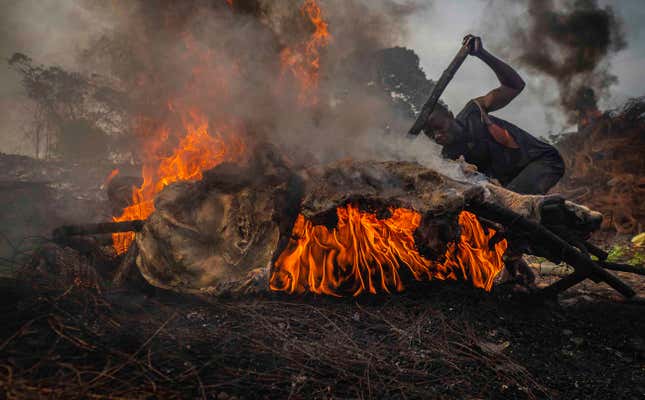Atop mounds of copper wire, animal bones, and discarded tires, fires burn day and night in Onitsha.