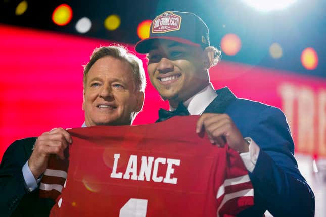 North Dakota State quarterback Trey Lance, right, holds a jersey with NFL Commissioner Roger Goodell after being chosen by the San Francisco 49ers with the third pick in the first round of the NFL football draft Thursday, April 29, 2021, in Cleveland.