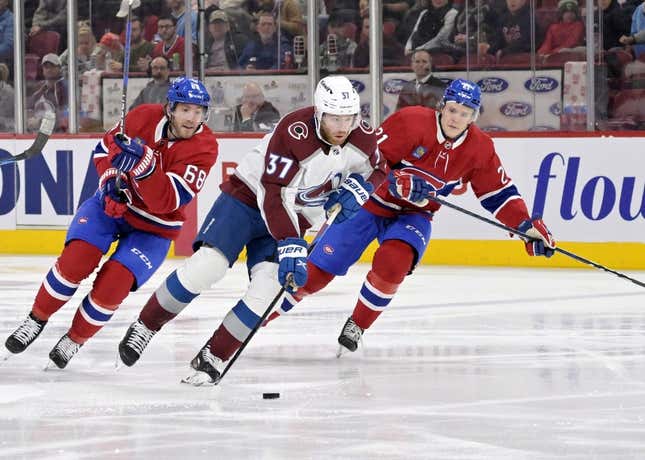 Mar 13, 2023; Montreal, Quebec, CAN; Colorado Avalanche forward J.T. Compher (37) plays the puck and Montreal Canadiens forward Mike Hoffman (68) defends with teammate defenseman Kaiden Guhle (21) during the second period at the Bell Centre.