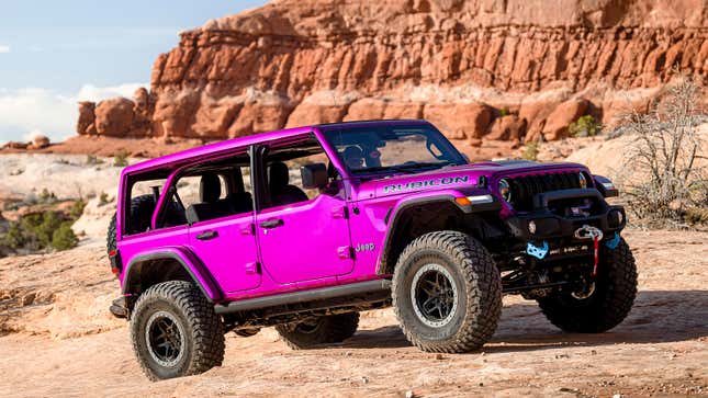 A photo of a bright pink Jeep Wrangler 4XE on the trails. 