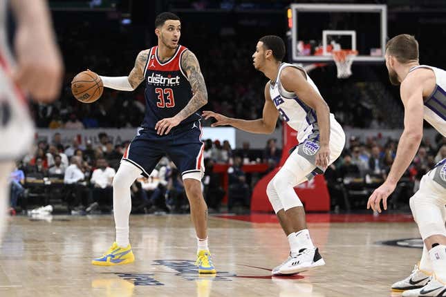 Mar 18, 2023; Washington, District of Columbia, USA; Washington Wizards forward Kyle Kuzma (33) dribbles as Sacramento Kings forward Keegan Murray (13) defends during the second half at Capital One Arena.