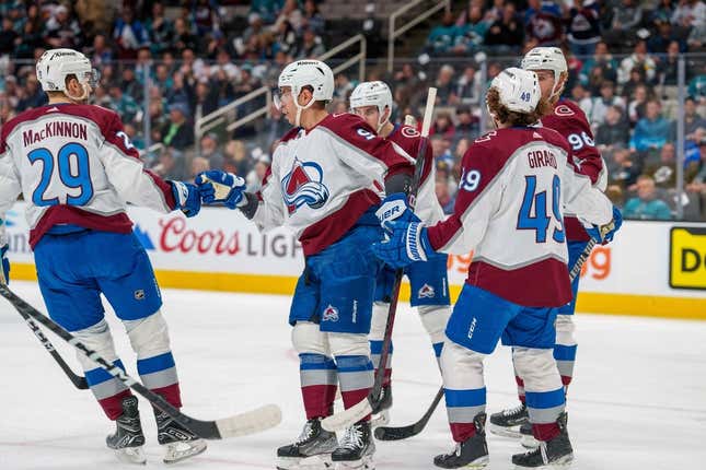 Apr 4, 2023; San Jose, California, USA;  Colorado Avalanche center Evan Rodrigues (9) and Colorado Avalanche center Nathan MacKinnon (29) and teammates celebrate after the goal against the San Jose Sharks during the first period at SAP Center at San Jose.