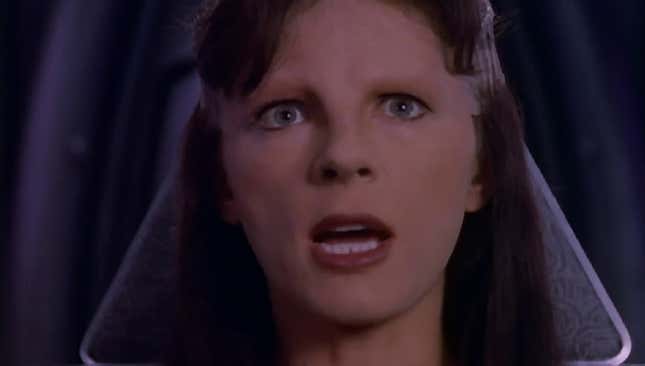 Mira Furlan looks shocked at Delenn in Babylon 5.