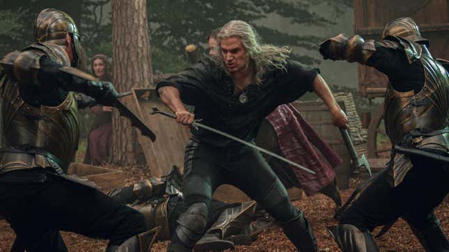 Henry Cavill fights two Nilfgaardian soldiers in The Witcher