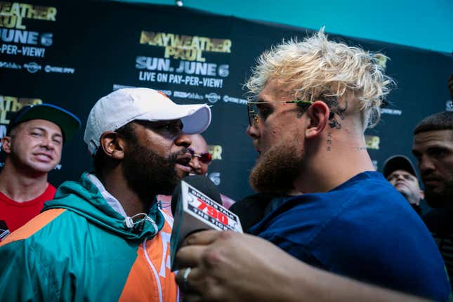 Floyd Mayweather (L) and Jake Paul pose during a press conference at Hard Rock Stadium, in Miami Gardens, Florida, on May 6, 2021.