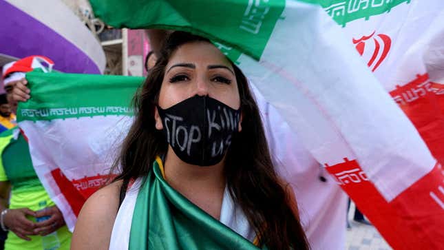 A women wears a protest facemask at the Iran US match