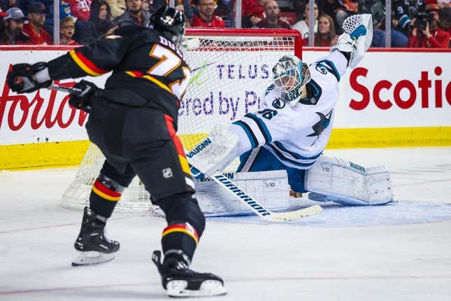 Mar 25, 2023; Calgary, Alberta, CAN; Calgary Flames right wing Walker Duehr (71) scores a goal against San Jose Sharks goaltender Kaapo Kahkonen (36) during the second period at Scotiabank Saddledome.