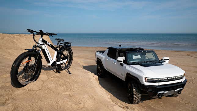 A photo of a Hummer-badged E Bike next to a Hummer electric SUV. 