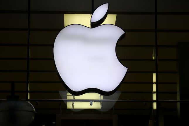 FILE - The Apple logo is illuminated at a store in the city center in Munich, Germany, on Dec. 16, 2020. Apple Corp. shares have been sliding, Friday, Sept. 8, 2023 weighed down by news reports of an iPhone ban for Chinese state employees and a product launch next week overshadowed by slick new phones by rival Huawei. (AP Photo/Matthias Schrader, File)