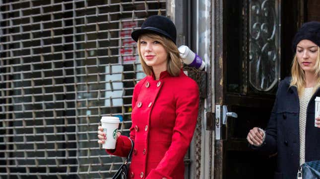 Taylor Swift in red coat with a Starbucks coffee