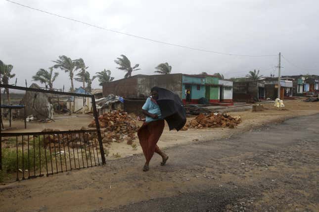A villager walks towards a shelter as heavy rain and wind gusts rip through Orissa