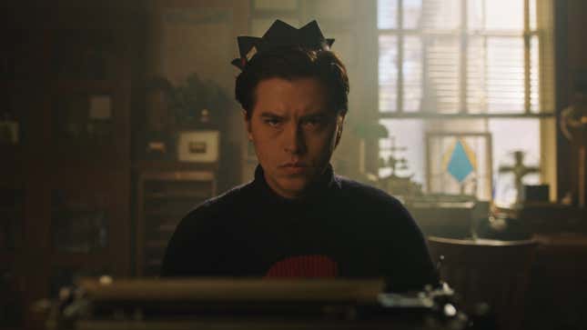 Jughead, in his trademark whoopee cap, sits at a typewriter and stares angrily at the viewer.