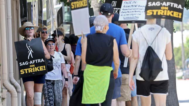 SAG-AFTRA and WGA workers strike outside of Warner Bros. in Burbank, CA