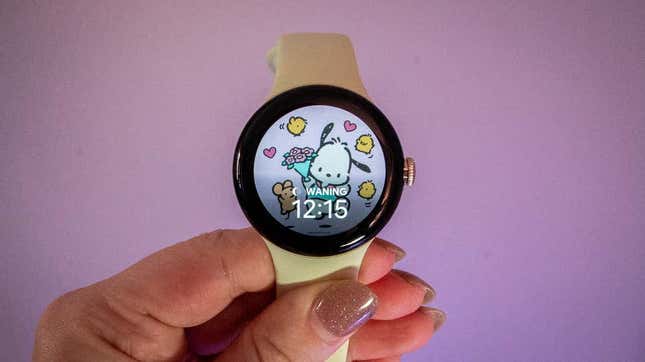 A photo of a person holding up the Pixel Watch 