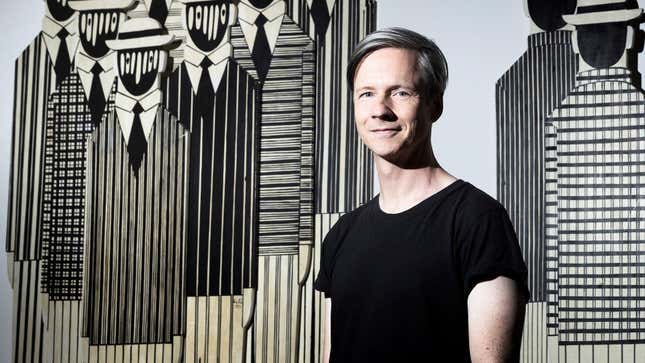 John Cameron Mitchell poses in front of an artwork by Gaetis during a photo session in the ARP studios in Paris on June 13, 2018