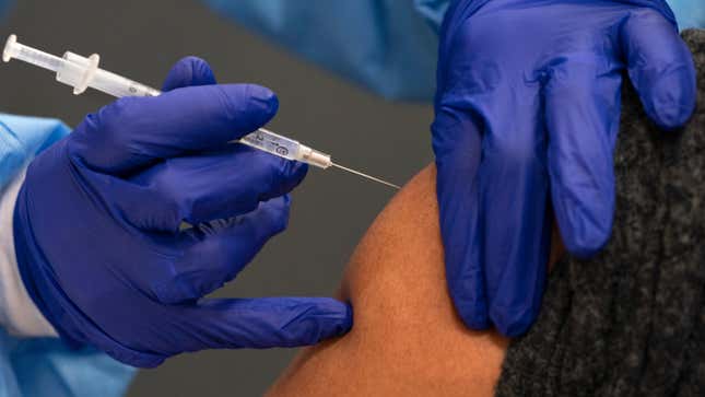 In this Thursday, Feb. 11, 2021, photo a person receives their second dose of the COVID-19 vaccine at a clinic at Howard University, in Washington.