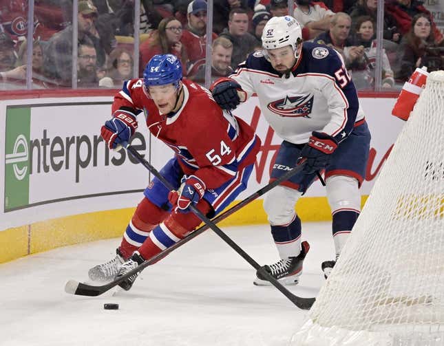 Mar 25, 2023; Montreal, Quebec, CAN; Montreal Canadiens defenseman Jordan Harris (54) plays the puck and Columbus Blue Jackets forward Emil Bemstrom (52) forechecks during the first period at the Bell Centre.