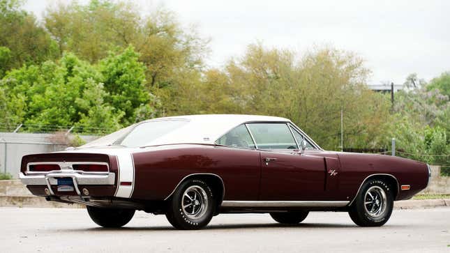 A photo of a burgundy Dodge Charger. 