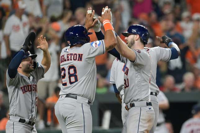 Aug 8, 2023; Baltimore, Maryland, USA; Houston Astros right fielder Kyle Tucker (30) celebrates with pinch hitter John Singleton (28) and second baseman Jose Altuve (27) at home pate after hitting a grand slam in the ninth inning against the Baltimore Orioles  at Oriole Park at Camden Yards.