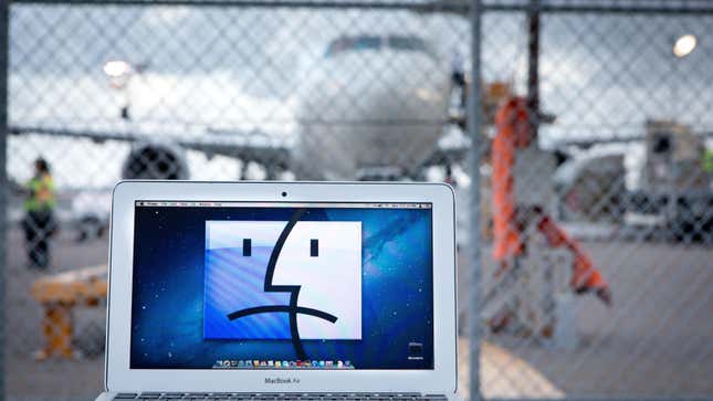 Due to security reasons cabin laptops are banned on certain flights: Apple notebook showing a sad face at a fence at San Diego International Airport, in March 2017.