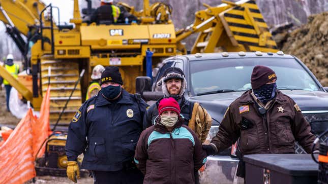 Aitkin County sheriffs arrest water protectors during a protest at the construction site of the Line 3 oil pipeline near Palisade, Minnesota. If it were Montana, the fines could soon be astronomical.