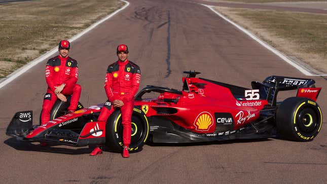 A photo of Charles LecLerc and Carlos Sainz sat on the 2023 Ferrari Formula 1 car. 