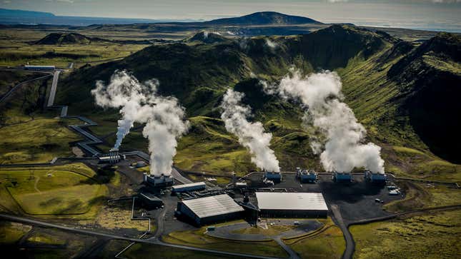 An aerial view of the Hellisheidi Geothermal Park in Iceland with steam billowing up.