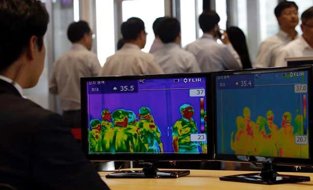 Thermal camera monitors show the body temperature of visitors.