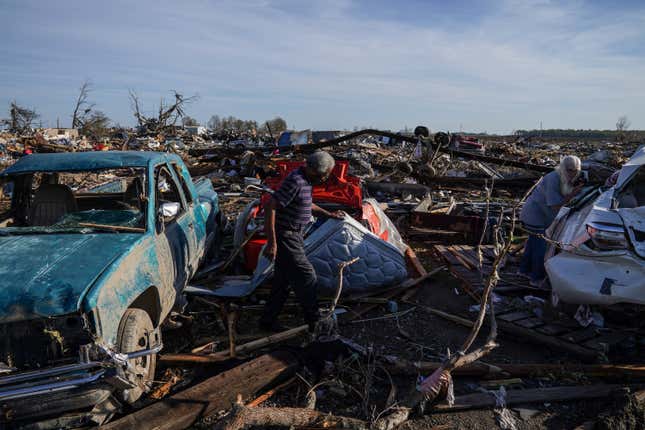 ROLLING FORK, MS - MARCH 27: Charles Jones Sr., L, and Edna Kent Jones look for any valuables they can where Charless son and the sons family were badly injured when a disastrous tornado tore through their mobile home park just outside Rolling Fork, on March 27, 2023