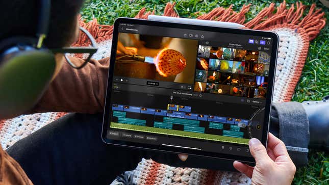 A user on a blanket on a patch of grass running Final Cut Pro for iPad on an iPad.