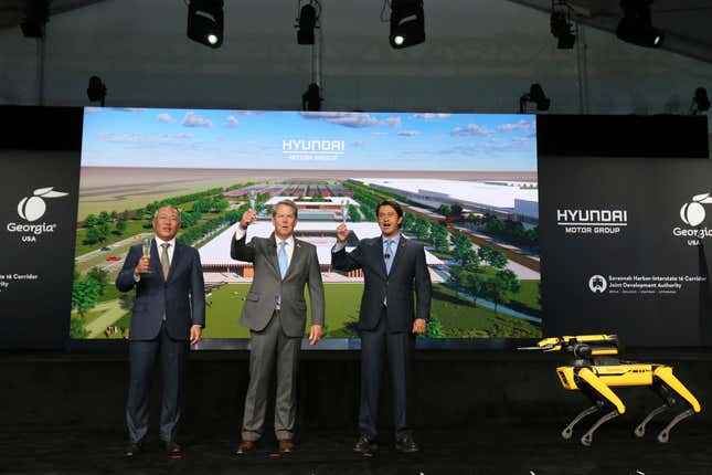 FILE - Chung Eui-sun, left, executive chairman of Hyundai Motor Group, Georgia Gov. Brian Kemp, and Jose Munoz, president and COO of Hyundai, celebrate with a champagne toast during the official groundbreaking for the Hyundai Meta Plant on Oct. 25, 2022 in Ellabell, Ga. Georgia and local governments are now projected to give Hyundai $2.1 billion of incentives after the company announced in August 2023 that it would increase investment in the plant by $2.1 billion. (Richard Burkhart/Savannah Morning News via AP, File)