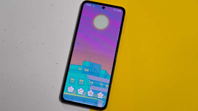 A photo of the Galaxy Z Flip 3 laid out flat on a yellow and speckled background