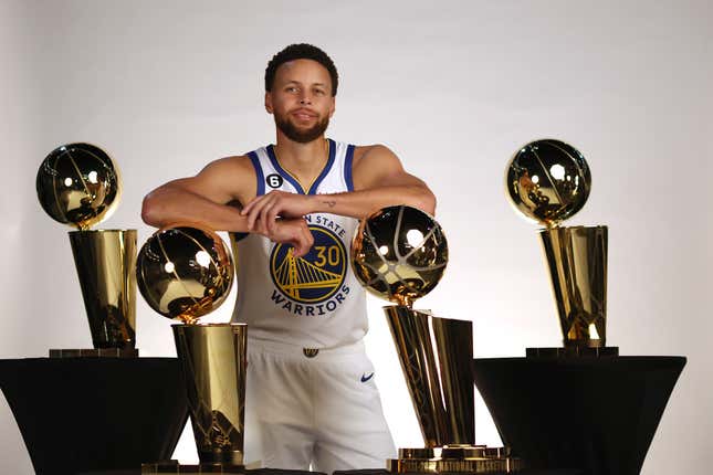 Stephen Curry #30 of the Golden State Warriors poses with the four Larry O’Brien Championship Trophies that he has won with the Warriors during the Warriors Media Day on September 25, 2022 in San Francisco, California. (Photo by Ezra Shaw/Getty Images)