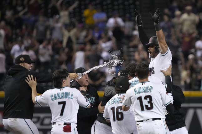 Aug 21, 2023; Phoenix, Arizona, USA; Arizona Diamondbacks left fielder Tommy Pham (28) celebrates with temamates after hitting a two run walk off double during the eleventh inning against the Texas Rangers at Chase Field.