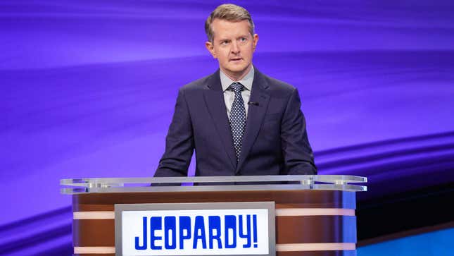 A photo shows Ken Jennings behind the Jeopardy host podium. 